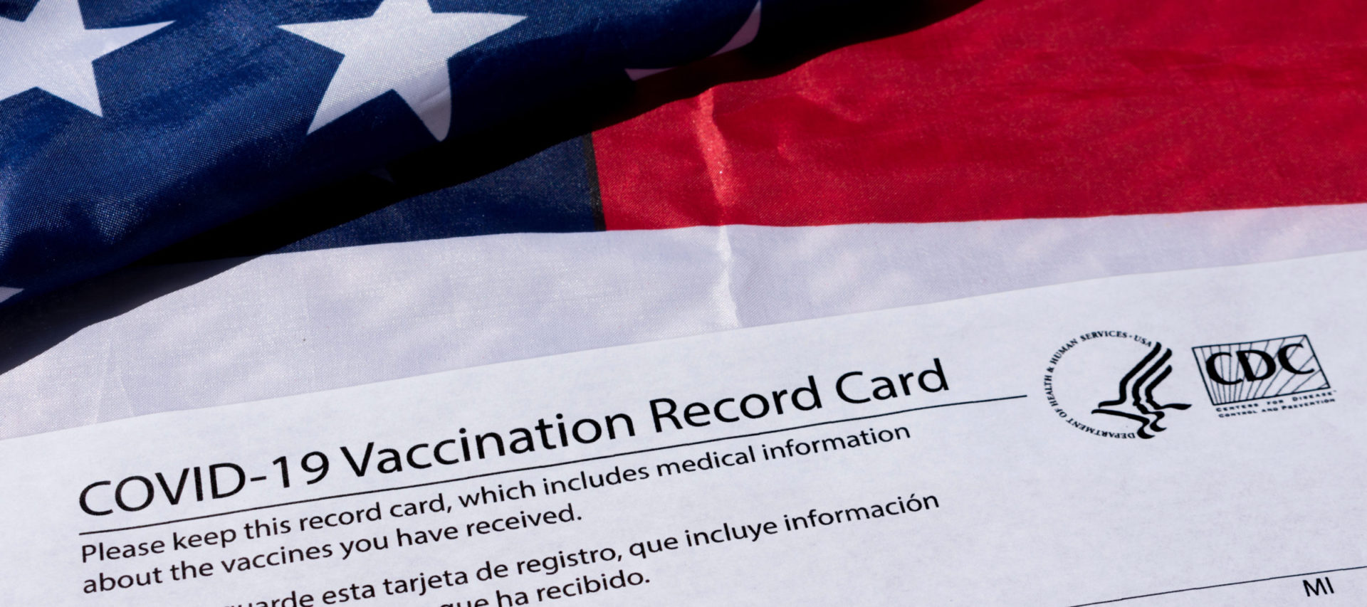 Vaccine card and American flag